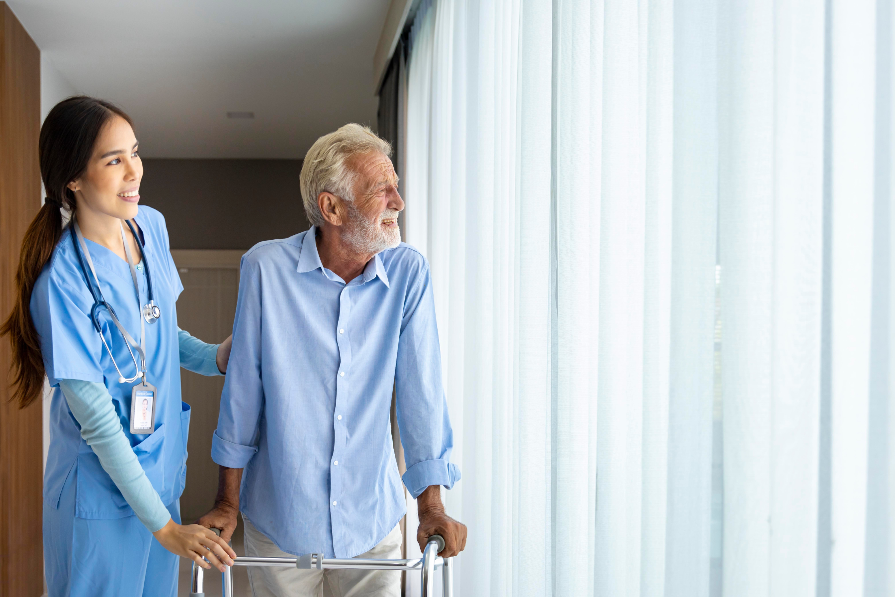 nurse-and-patient-looking-out-the-window_511203917
