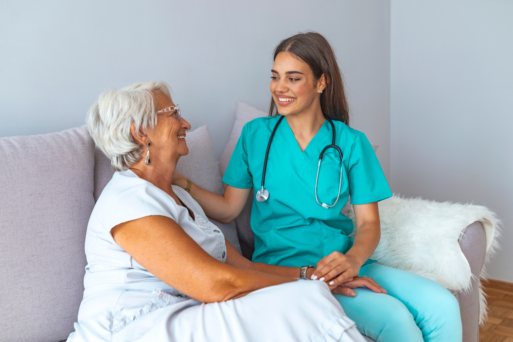 nurse-and-patient-sitting-together_248445418